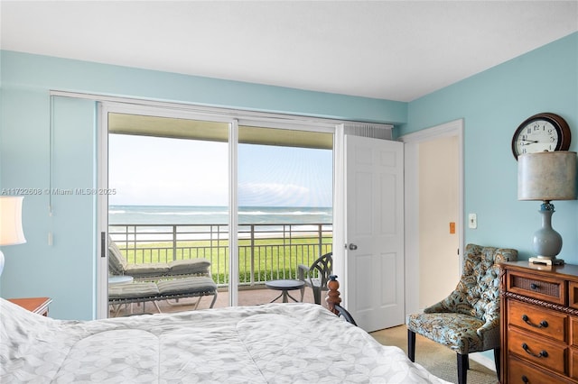 carpeted bedroom featuring a water view, access to outside, and multiple windows