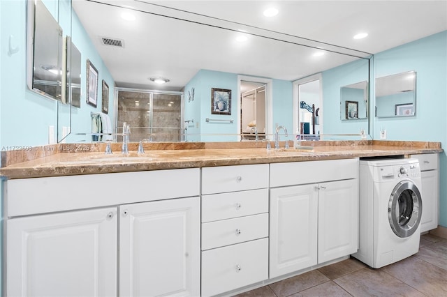 bathroom with vanity, washer / clothes dryer, tile patterned floors, and walk in shower