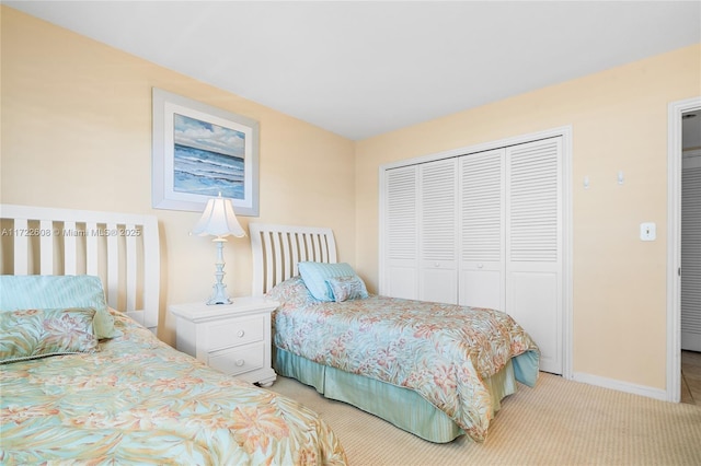 bedroom with light carpet and a closet