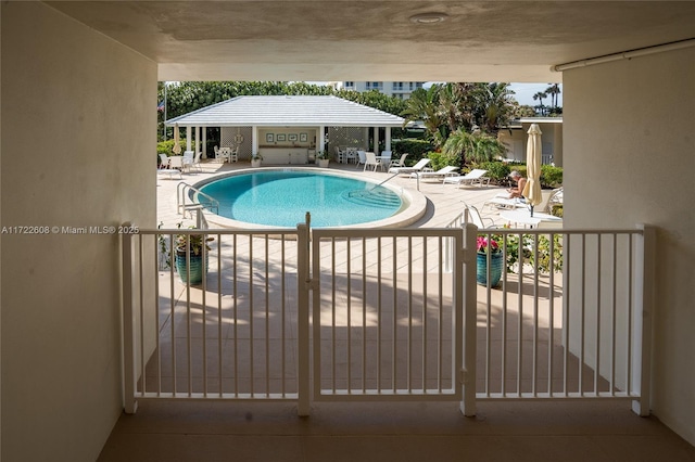 view of swimming pool with a patio area