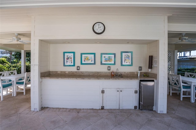 interior space with ceiling fan and sink