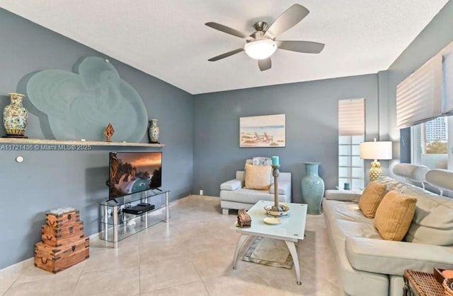 living room featuring ceiling fan and light tile patterned floors