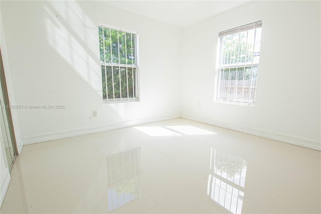 spare room featuring tile patterned flooring