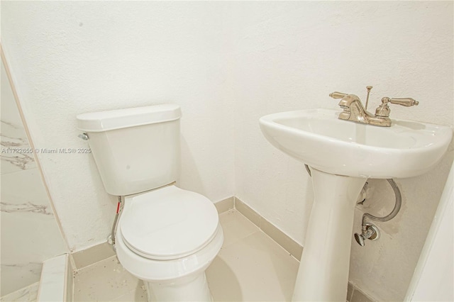 bathroom featuring tile patterned flooring and toilet