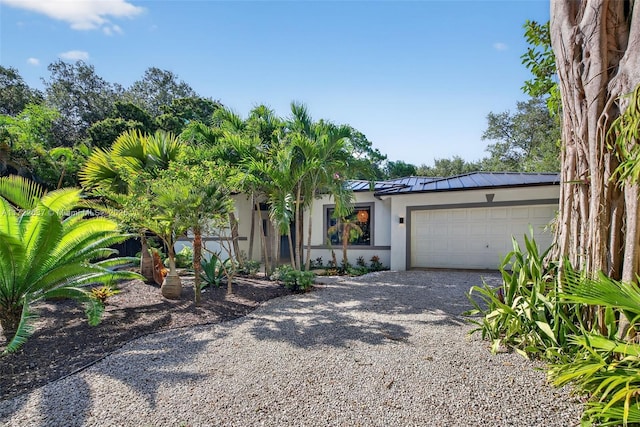 1511 SW 30th Pl, Fort Lauderdale, FL 33315 - view of front facade with stucco siding, driveway, a garage, and a metal roof