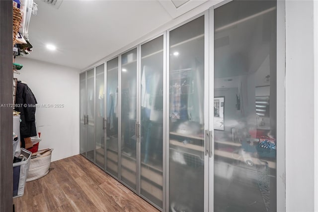 walk in closet featuring hardwood / wood-style floors