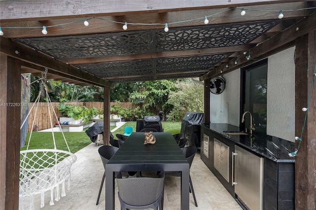 view of patio with a pergola, sink, and exterior kitchen