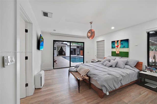 bedroom with access to exterior and light wood-type flooring