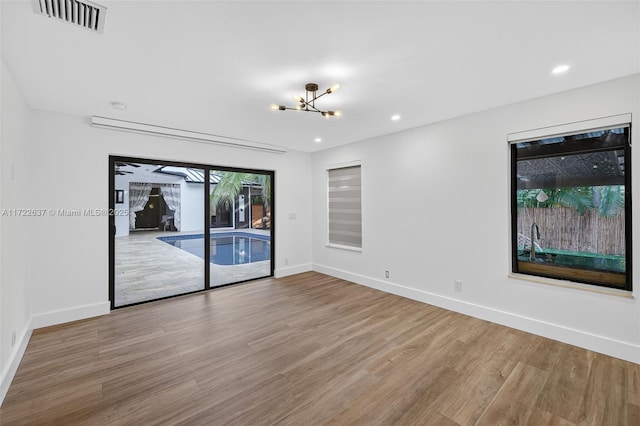 1511 SW 30th Pl, Fort Lauderdale, FL 33315 - spare room with a chandelier, wood finished floors, and recessed lighting