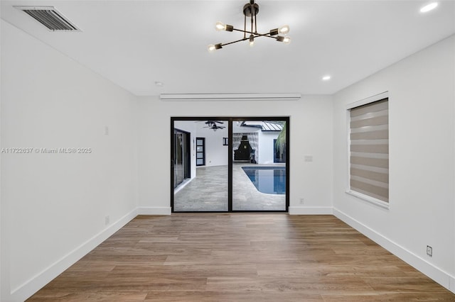 1511 SW 30th Pl, Fort Lauderdale, FL 33315 - unfurnished room featuring a chandelier, recessed lighting, and wood finished floors