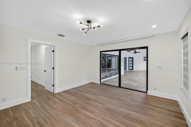 1511 SW 30th Pl, Fort Lauderdale, FL 33315 - unfurnished room featuring a chandelier, light wood-style flooring, and recessed lighting