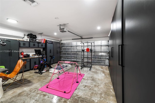 garage with stainless steel fridge, a garage door opener, and a wall mounted AC