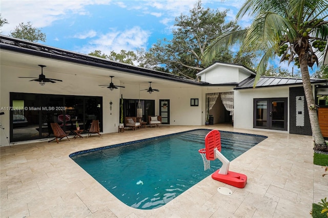 view of swimming pool with french doors, a patio, and ceiling fan