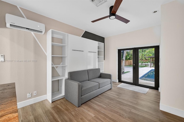 1511 SW 30th Pl, Fort Lauderdale, FL 33315 - unfurnished room featuring a wall unit AC, wood finished floors, a ceiling fan, and french doors