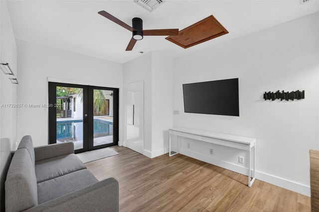 1511 SW 30th Pl, Fort Lauderdale, FL 33315 - living room featuring french doors, light wood finished floors, and ceiling fan