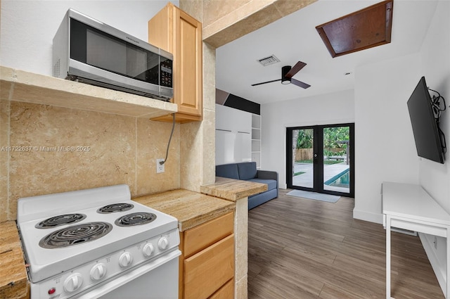 1511 SW 30th Pl, Fort Lauderdale, FL 33315 - kitchen with stainless steel microwave, electric stove, light brown cabinetry, a ceiling fan, and light countertops