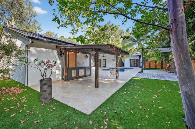 1511 SW 30th Pl, Fort Lauderdale, FL 33315 - back of property with stucco siding, a lawn, a patio, and french doors
