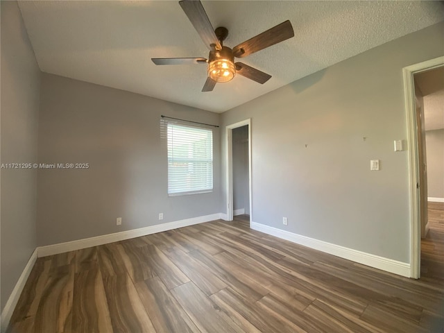 unfurnished room featuring ceiling fan, hardwood / wood-style floors, and a textured ceiling