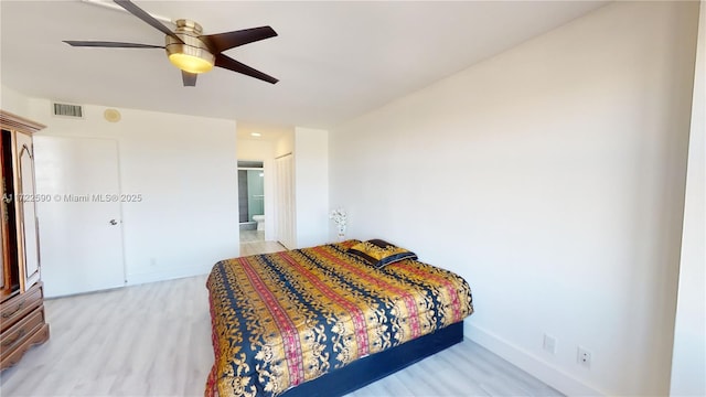 bedroom with connected bathroom, a closet, ceiling fan, and light hardwood / wood-style floors