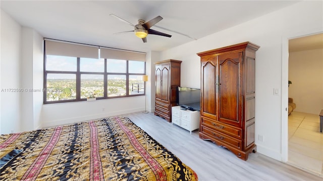 bedroom with ceiling fan and light hardwood / wood-style floors