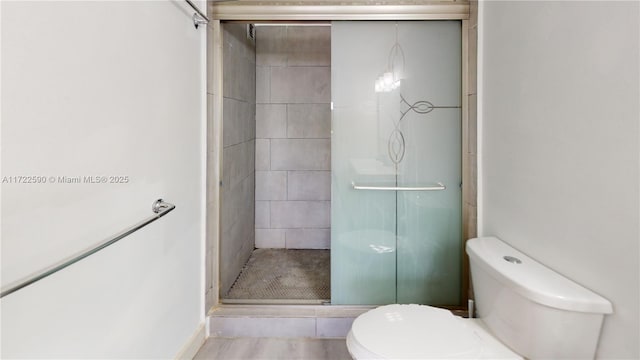 bathroom featuring an enclosed shower and toilet