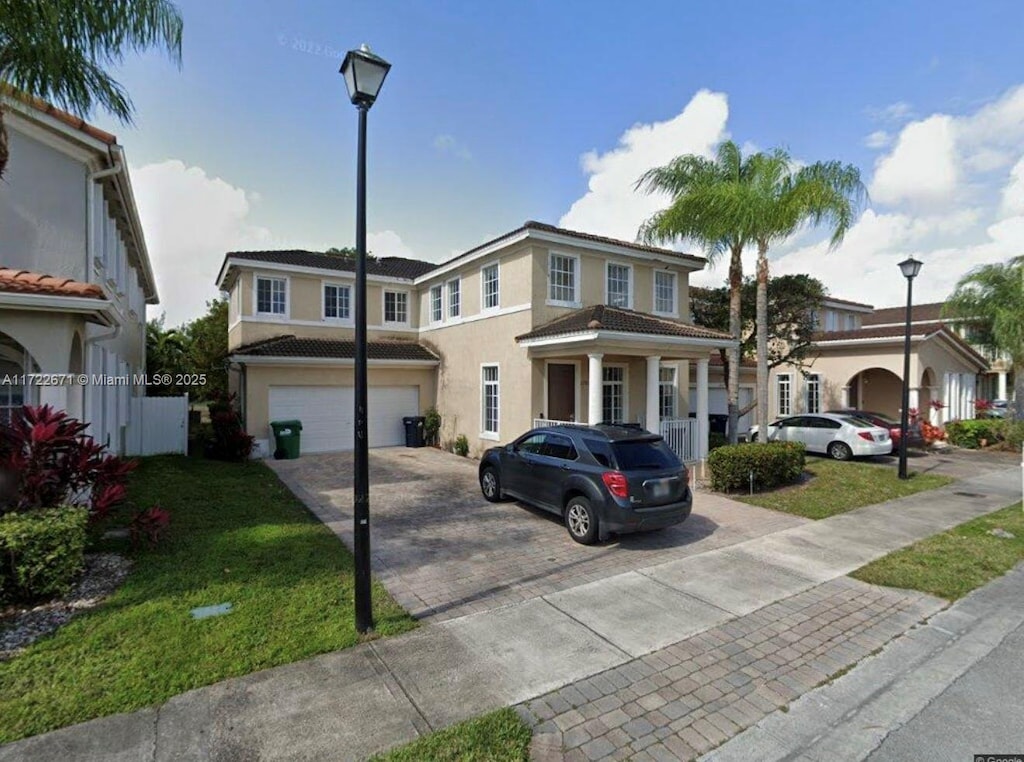 view of front of property with a front lawn and a garage