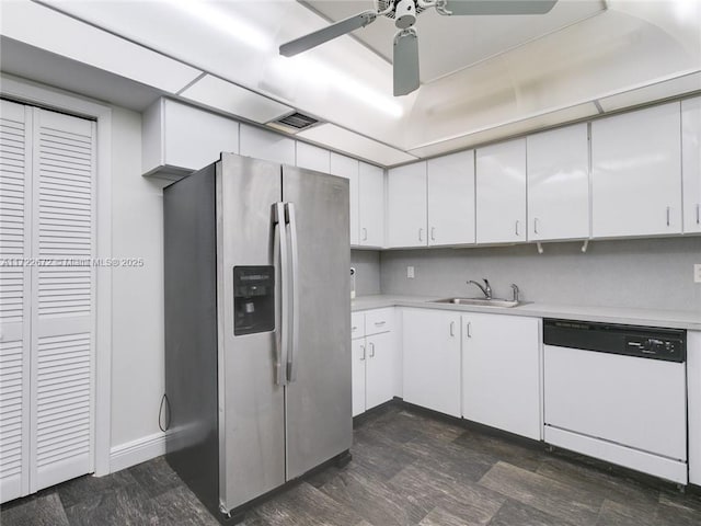 kitchen with white cabinets, stainless steel fridge, white dishwasher, and sink