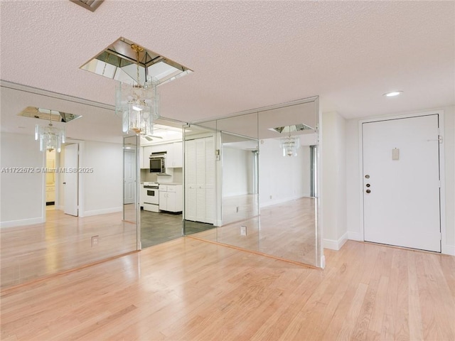 interior space featuring hardwood / wood-style flooring and a textured ceiling