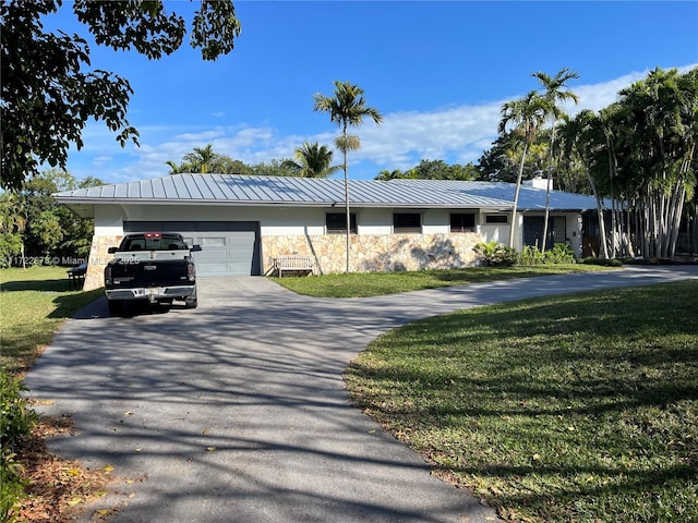 view of front of home featuring a garage and a front lawn