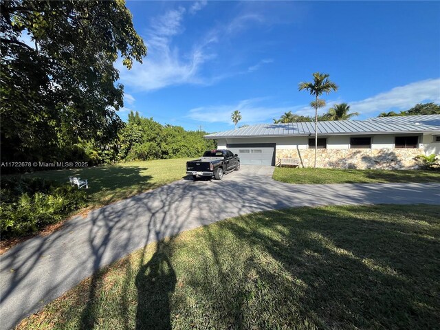 view of front facade with a garage and a front lawn