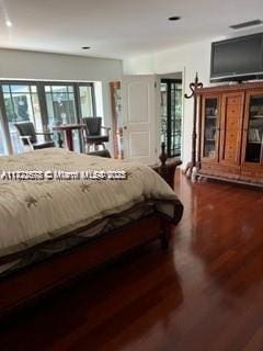 bedroom featuring multiple windows and hardwood / wood-style floors