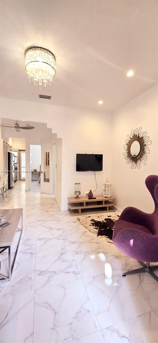 unfurnished living room with an inviting chandelier