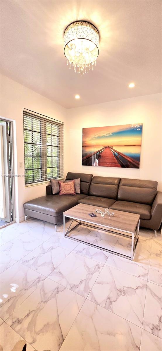 living room featuring a notable chandelier