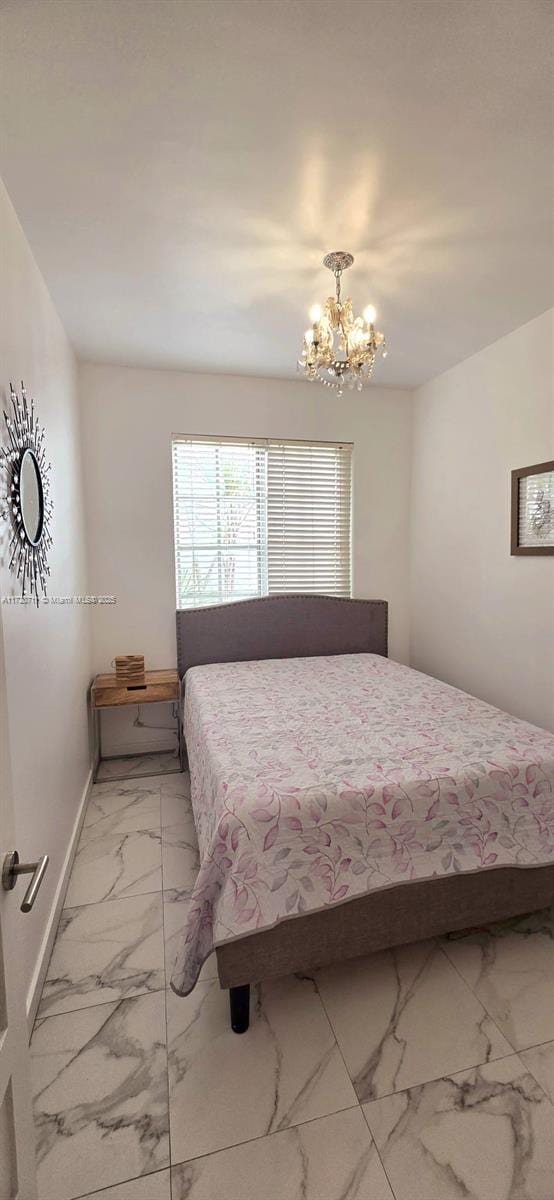 bedroom with a notable chandelier