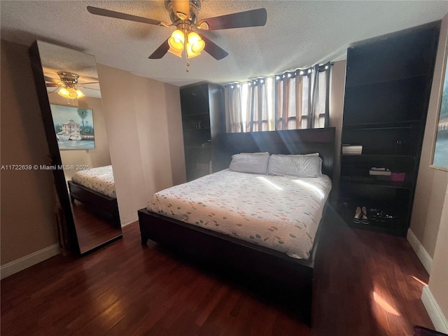 bedroom featuring dark hardwood / wood-style flooring, a textured ceiling, and ceiling fan