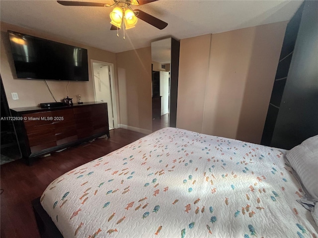 bedroom with dark wood-type flooring and ceiling fan