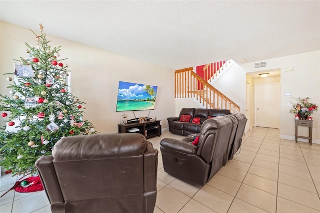 living room featuring light tile patterned floors and a textured ceiling