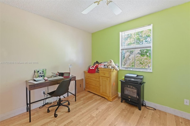 office area with a textured ceiling, ceiling fan, and light hardwood / wood-style floors