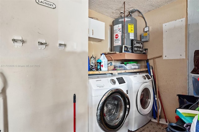 washroom with water heater, a textured ceiling, and separate washer and dryer