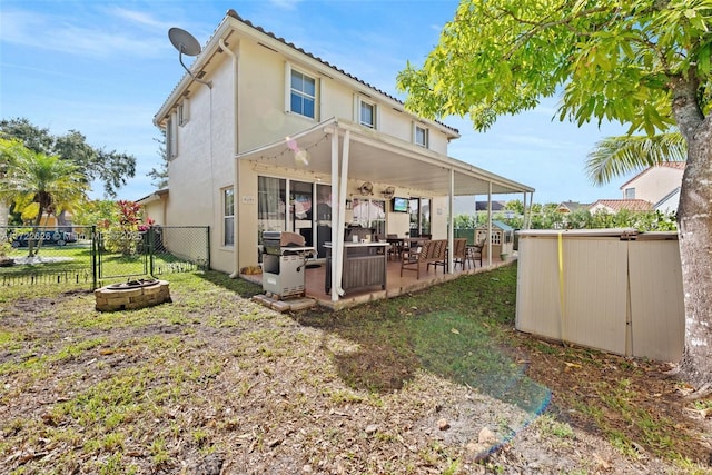 rear view of property featuring a patio area