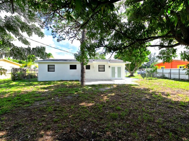 rear view of house featuring french doors