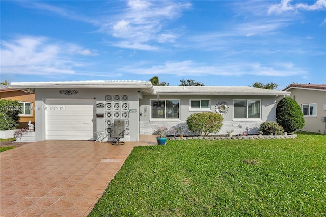 single story home with a front lawn and a garage