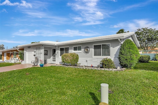 single story home with a garage and a front lawn