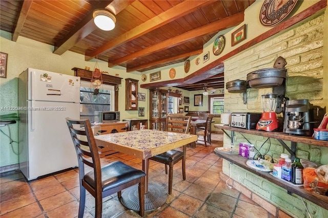 dining area featuring beamed ceiling, plenty of natural light, and wooden ceiling