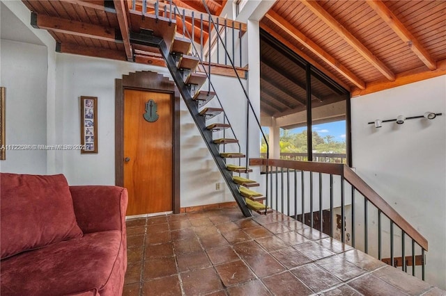 stairs with lofted ceiling with beams and wood ceiling