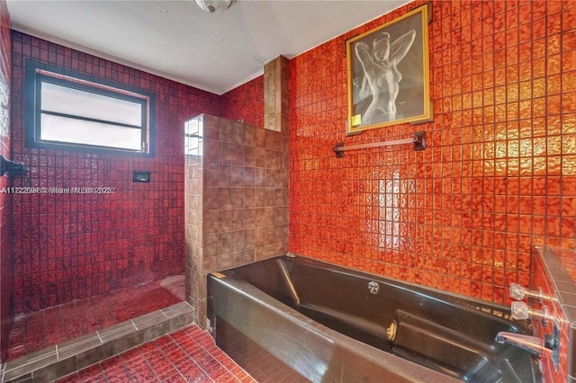 bathroom with tile patterned floors, tile walls, and plus walk in shower