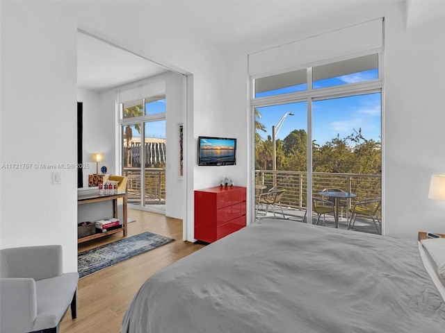 bedroom featuring hardwood / wood-style flooring and access to outside