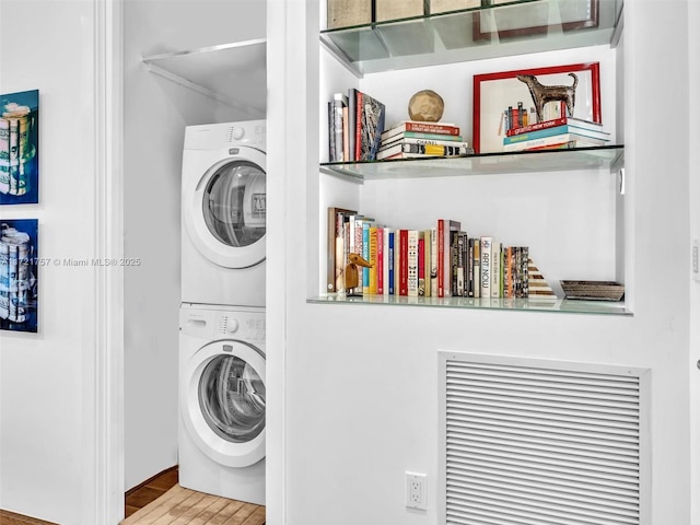 laundry room with stacked washer / dryer