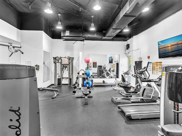 gym featuring a towering ceiling