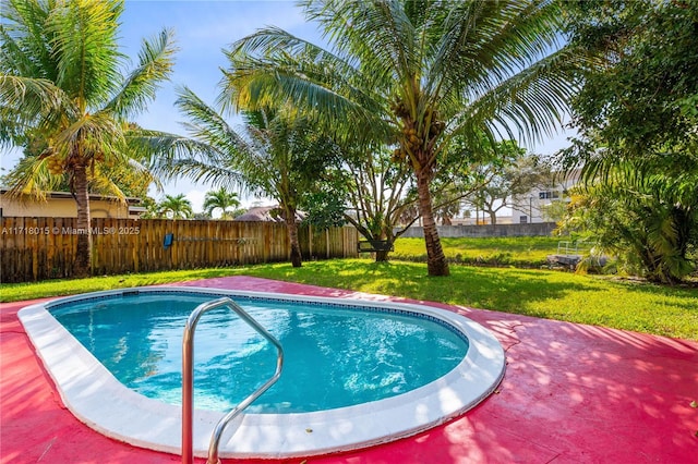 view of pool with a fenced in pool, a fenced backyard, and a yard